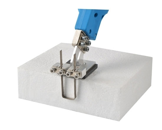Electric hot knife foam board cutter with a 150mm blade shaping a white block of expanded polystyrene foam.