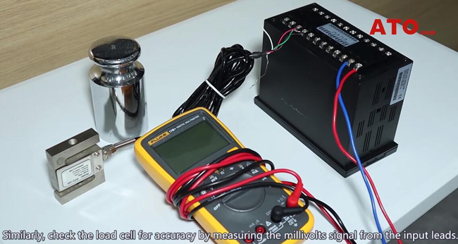 Load cell with a multimeter and power supply